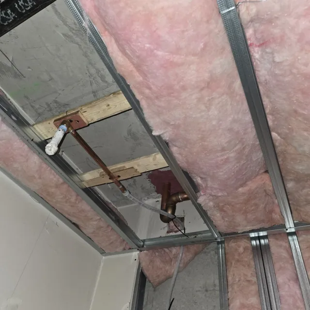 Supply pipework routed above an open ceiling