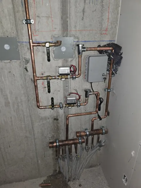 Copper distribution assembly and valves mounted at a wall