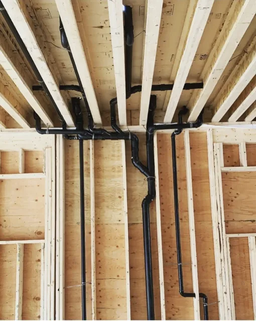 ABS drainage rough-in in an exposed timber-framed home