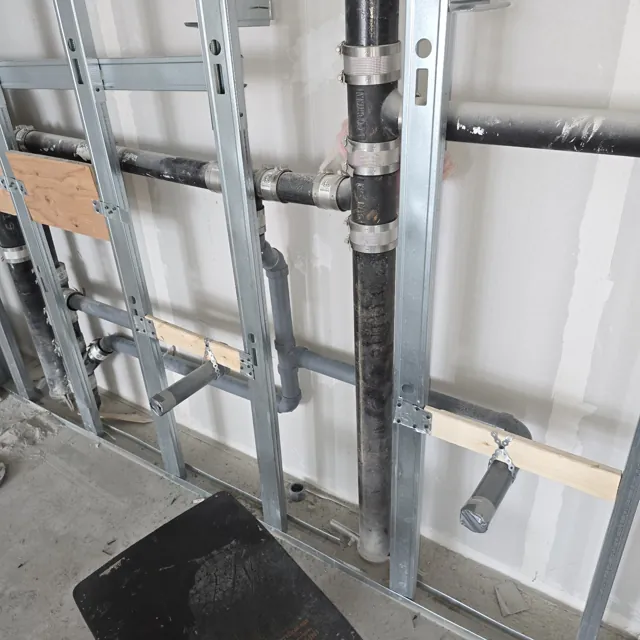 Vertical drainage and branch connections in steel framing