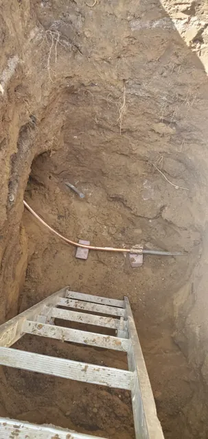 Excavation exposing a water-service line